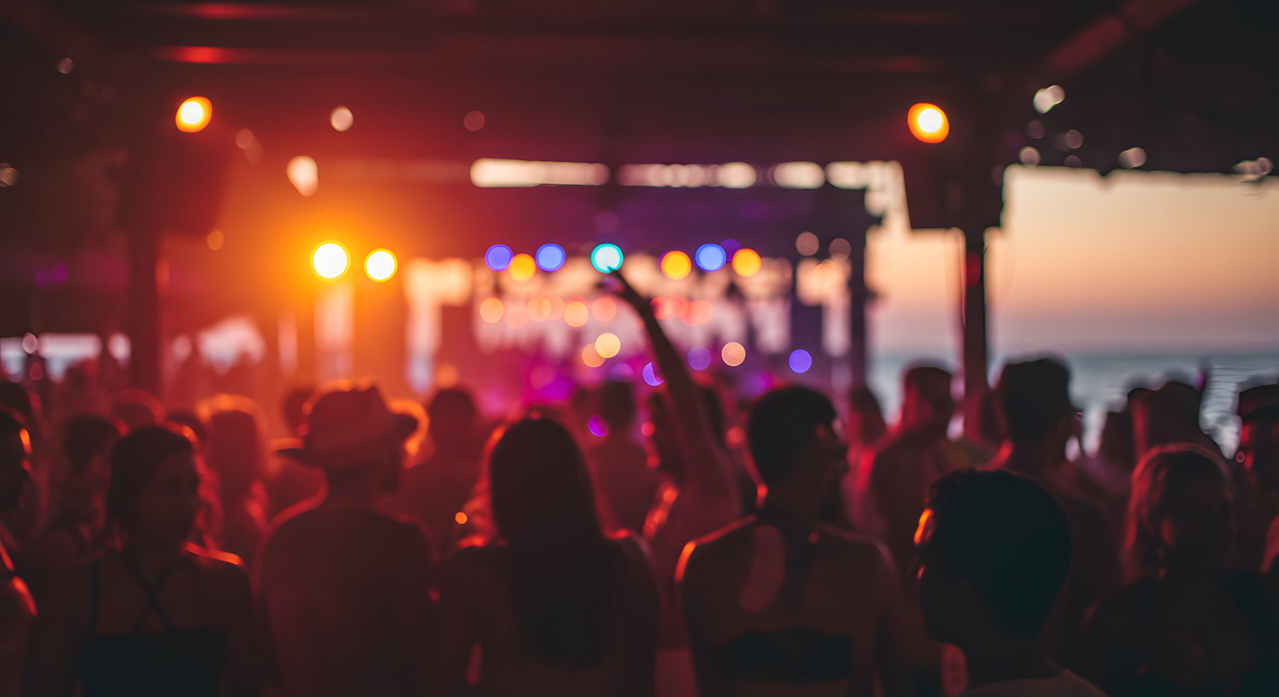 Blurred people having sunset beach party in summer vacation - Defocused image - Concept of nightlife with cocktails and music entertainment