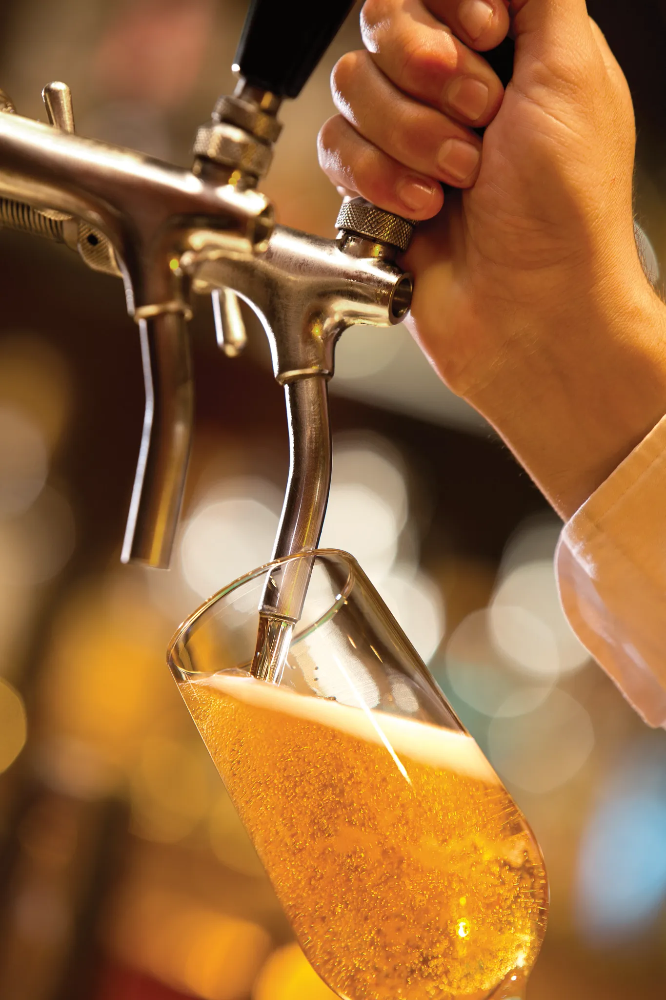After Dark bar at Secrets Riviera Cancun featuring draft beer on tap, illuminated bar setting, and lively nighttime atmosphere.