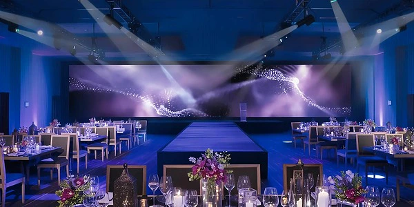 Elegant ballroom reception setup with stage and runway at Secrets Riviera Cancun