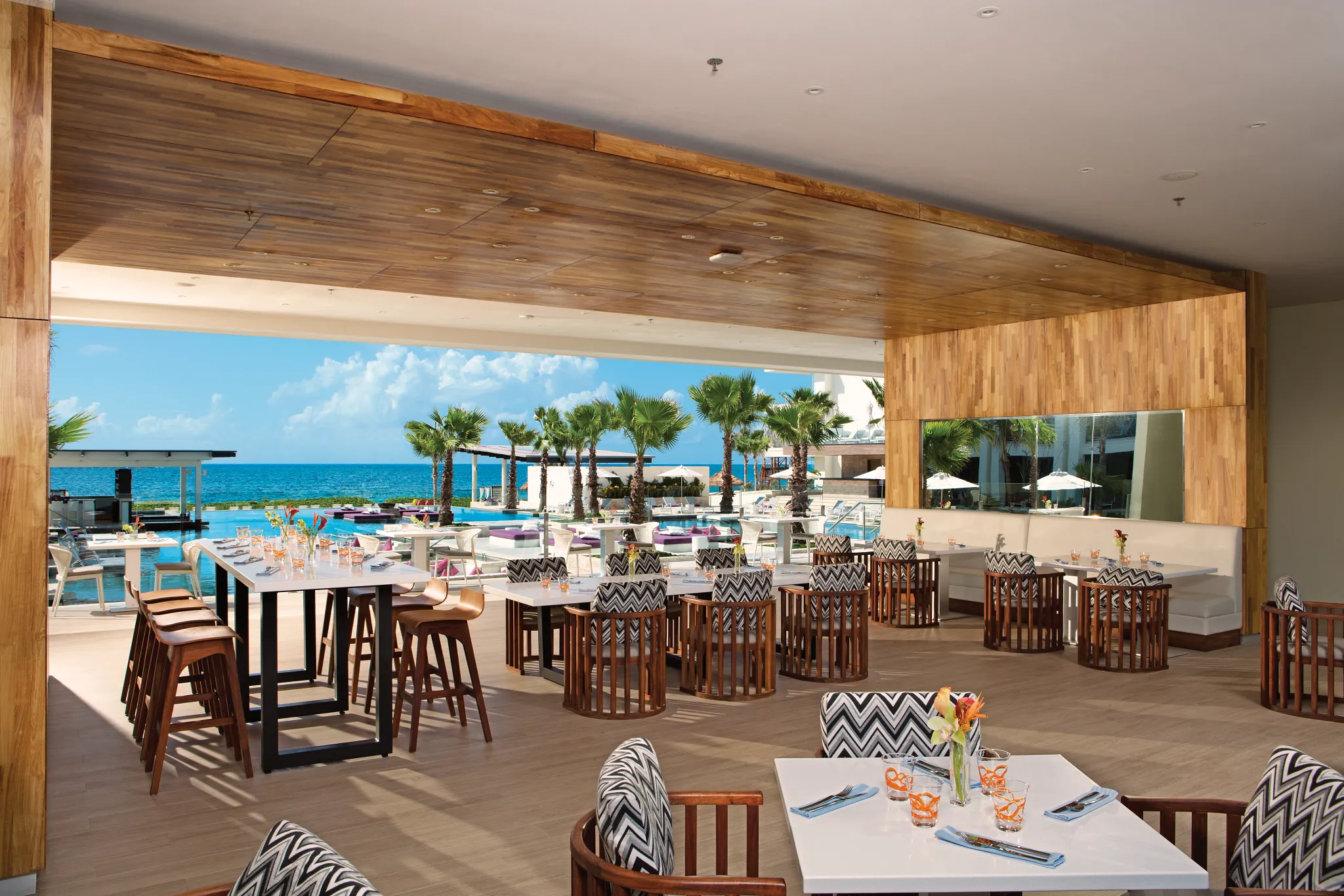 Bites restaurant at Secrets Riviera Cancun featuring open-air terrace dining, international tapas, and oceanfront views overlooking the pool.
