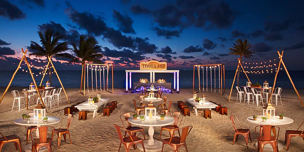 Energy Beach wedding reception setup at sunset at Secrets Riviera Cancun