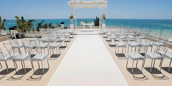Love Terrace oceanfront ceremony setup with white aisle at Secrets Riviera Cancun