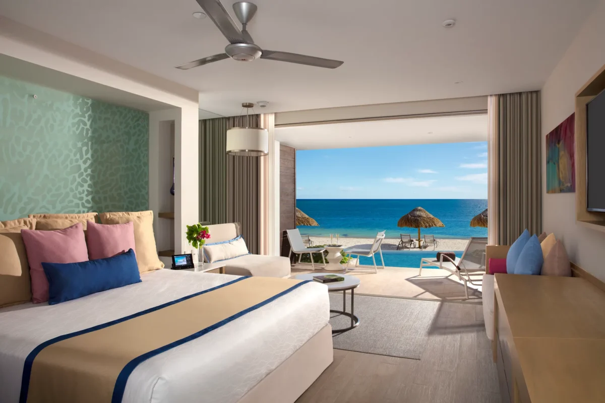 Preferred Club Junior Suite Swim Out Ocean Front with king bed and direct pool access at Secrets Riviera Cancun Resort & Spa.