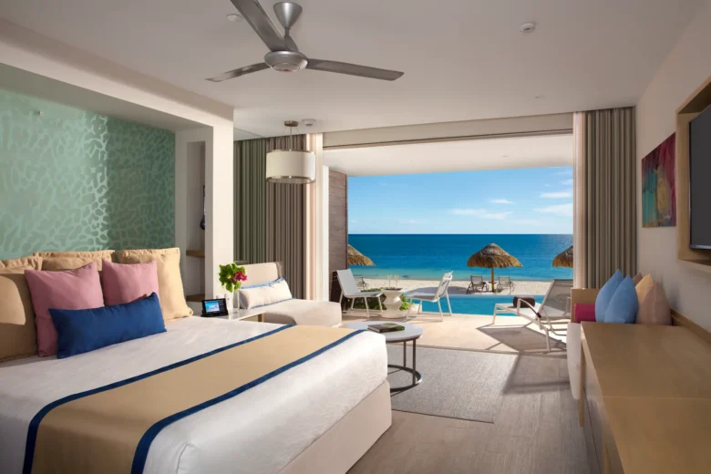 Preferred Club Junior Suite Swim Out Ocean Front with king bed and direct pool access at Secrets Riviera Cancun Resort & Spa.