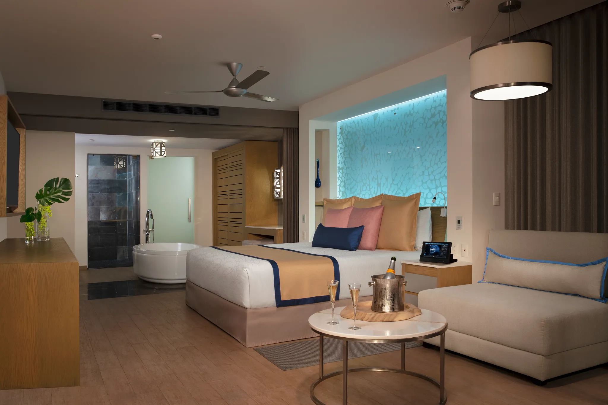 Preferred Club Master Suite Swim Out Tropical View bedroom with king bed and spa-style bathroom at Secrets Riviera Cancun.