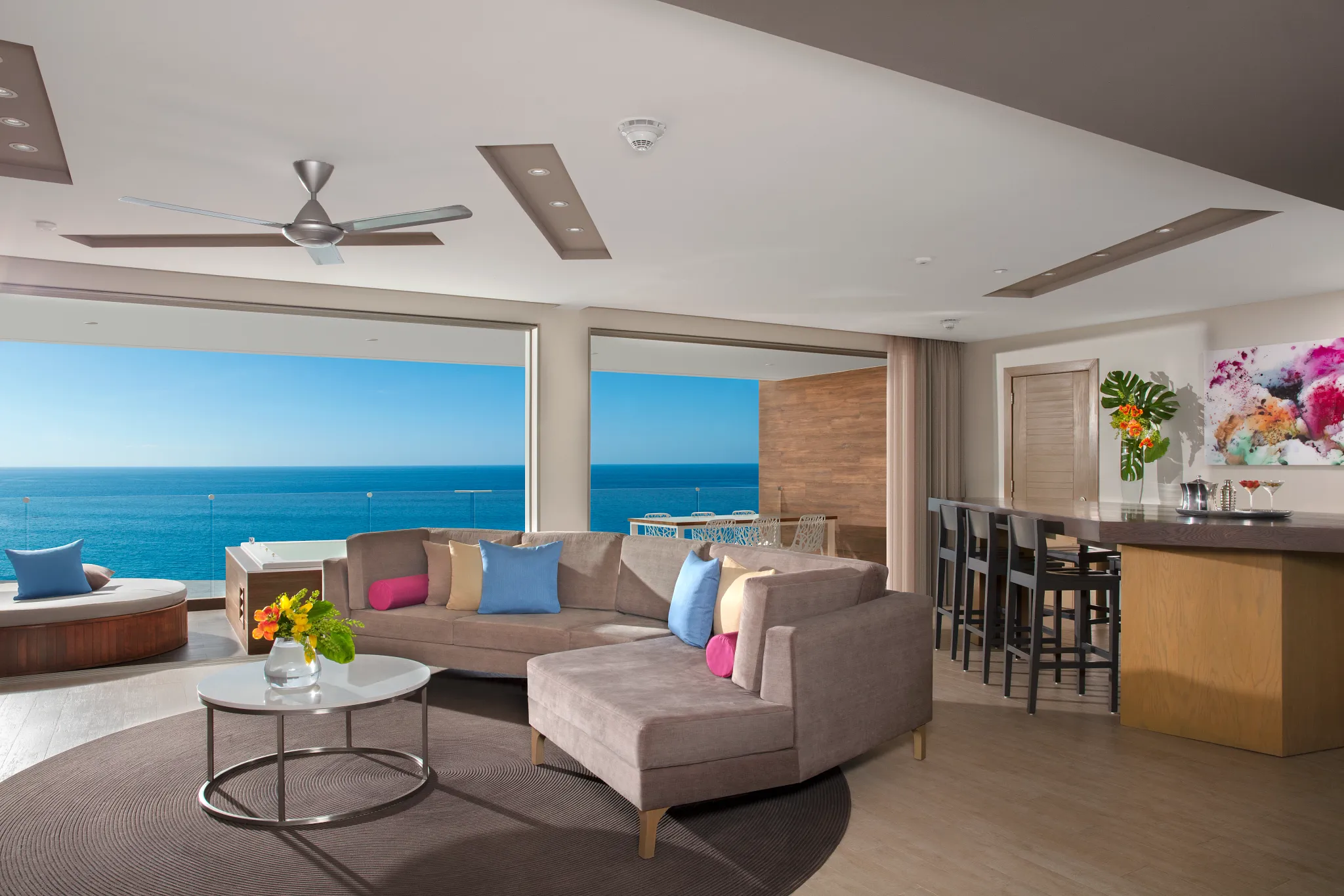 Preferred Club Presidential Suite Ocean Front living room and dining area with ocean views at Secrets Riviera Cancun.