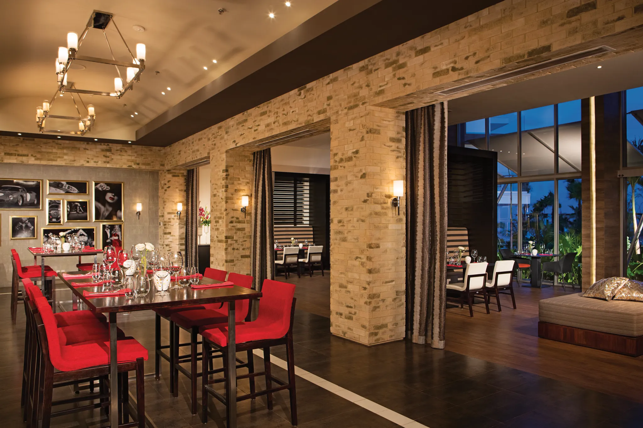 Spumante Italian restaurant at Secrets Riviera Cancun featuring elegant dining room, red upholstered chairs, and warm ambient lighting.
