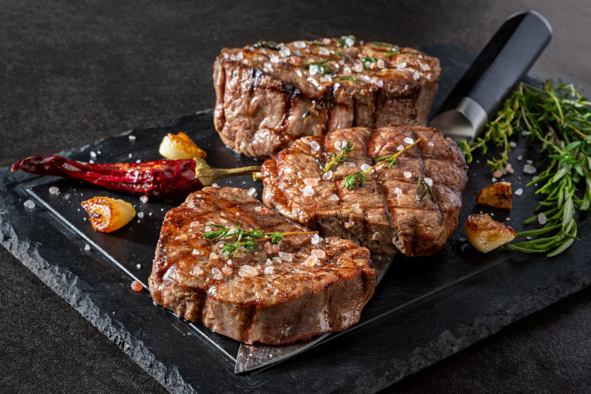 The Strip Grill at Secrets Riviera Cancun featuring premium grilled steaks with sea salt, herbs, and Caribbean Sea views.