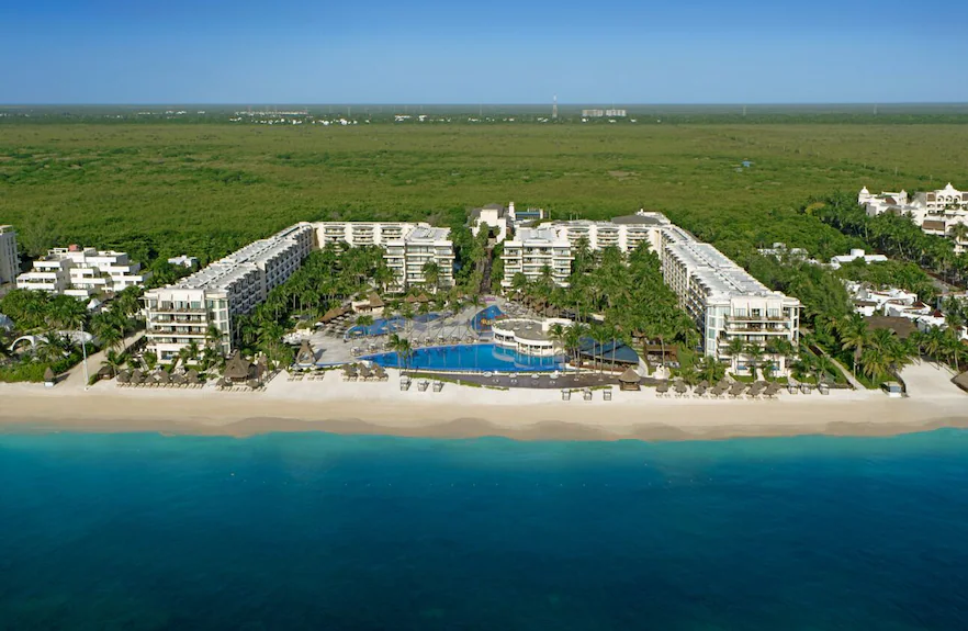 Dreams Riviera Cancun family-friendly all-inclusive resort in Puerto Morelos with tropical pools, white sand beach, and lush gardens.
