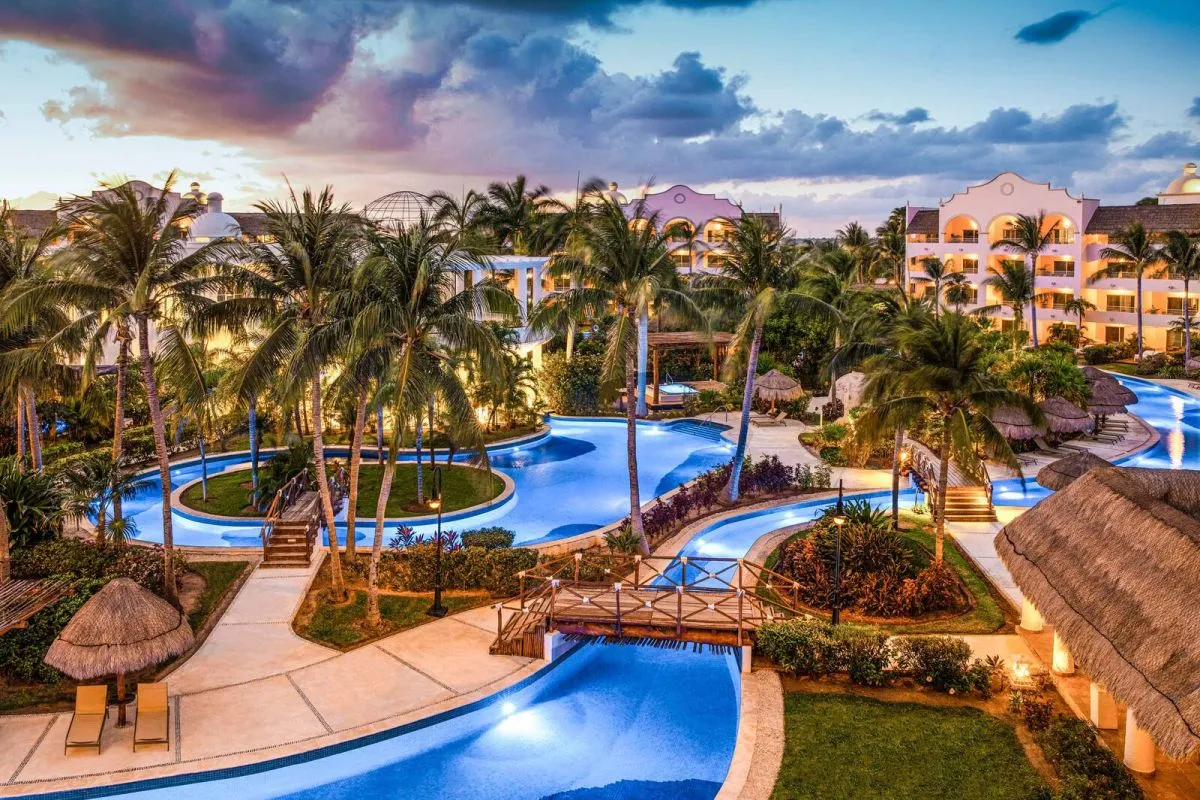 Excellence Riviera Cancun adults-only all-inclusive luxury resort with beachfront pools, swim-up suites, and elegant grounds near Puerto Morelos.